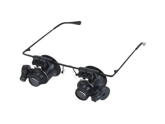 Gafas lupa binoculares con aumento 20× e iluminación LED integrada, ideales para trabajos de precisión y lectura detallada.